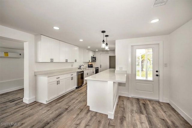 kitchen featuring a sink, visible vents, white cabinetry, light countertops, and appliances with stainless steel finishes