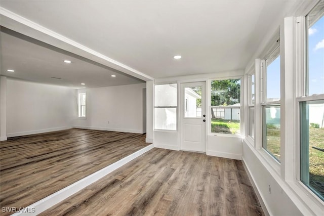 interior space featuring recessed lighting, baseboards, and wood finished floors