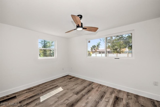 empty room featuring ceiling fan, wood finished floors, and baseboards