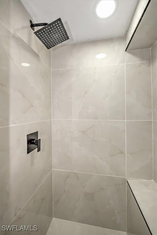 interior details with a tile shower