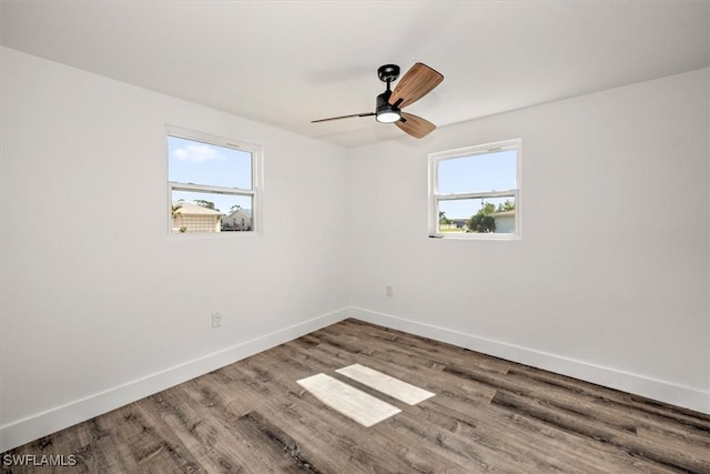 empty room featuring ceiling fan, wood finished floors, and baseboards