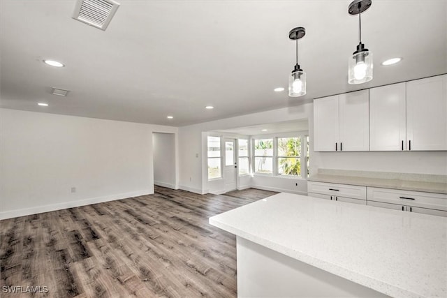 kitchen with decorative light fixtures, recessed lighting, visible vents, light wood-style floors, and white cabinets