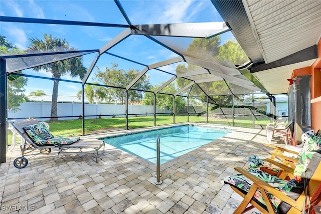 view of pool featuring a yard, a lanai, and a patio