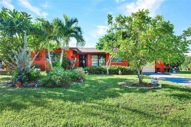 view of front of property with a garage and a front yard