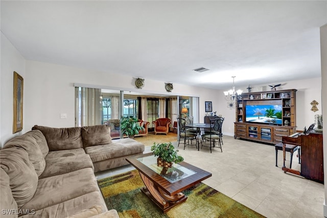 living room with light tile patterned floors and a chandelier