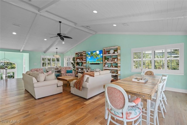 living room featuring light hardwood / wood-style floors, vaulted ceiling with beams, and a healthy amount of sunlight