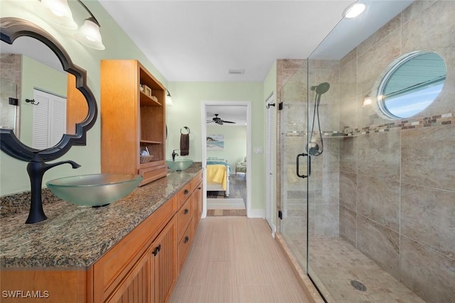 bathroom with an enclosed shower and vanity