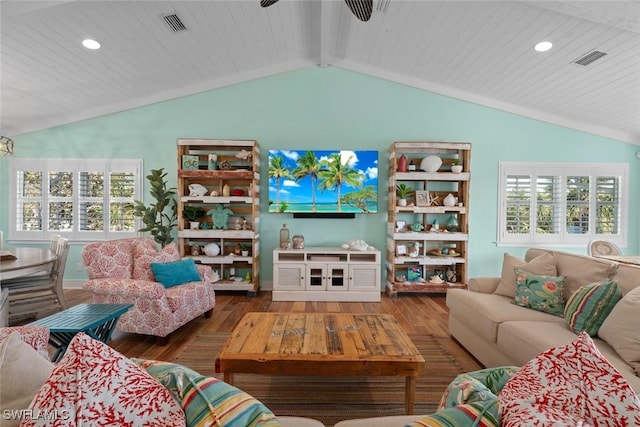 living room with ceiling fan, vaulted ceiling with beams, and hardwood / wood-style floors