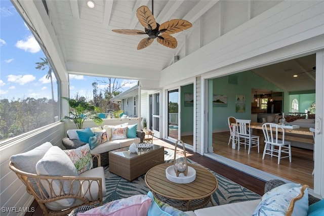 sunroom / solarium with ceiling fan and lofted ceiling