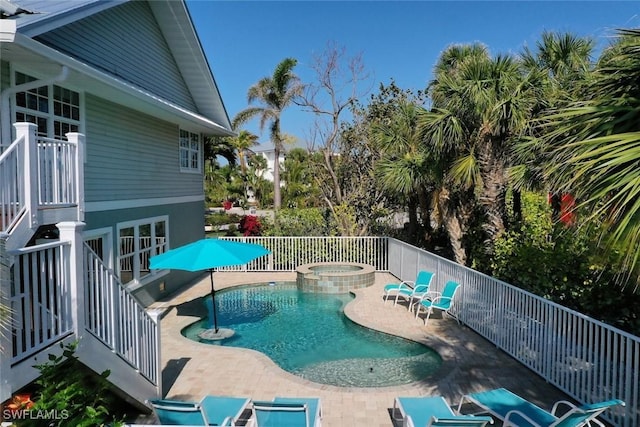 view of pool featuring a patio and an in ground hot tub