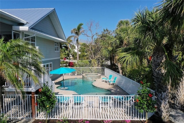 view of swimming pool featuring an in ground hot tub and a patio