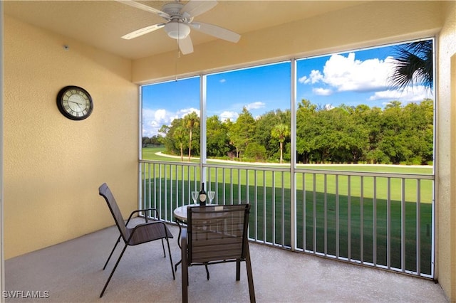 sunroom featuring ceiling fan