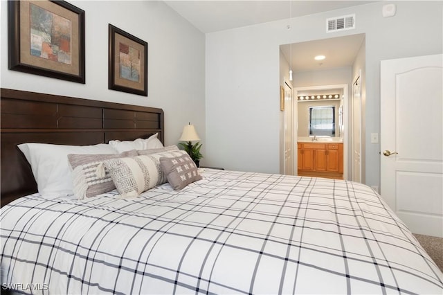 bedroom with ensuite bathroom and sink