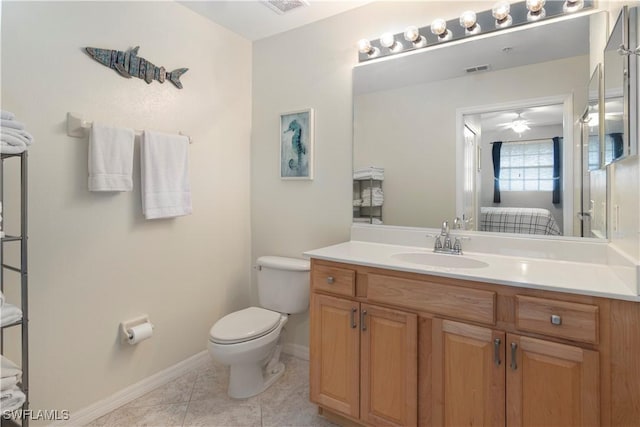 bathroom with tile patterned flooring, vanity, and toilet