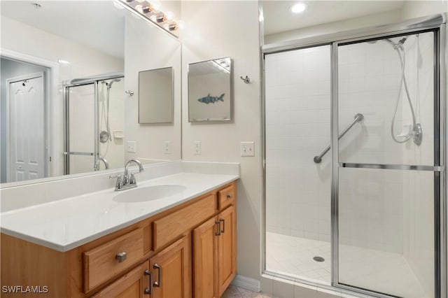 bathroom featuring vanity and a shower with shower door