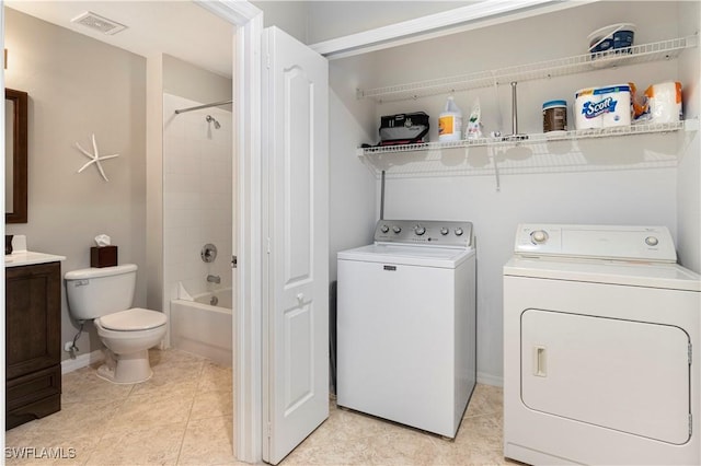 laundry area with light tile patterned flooring and independent washer and dryer