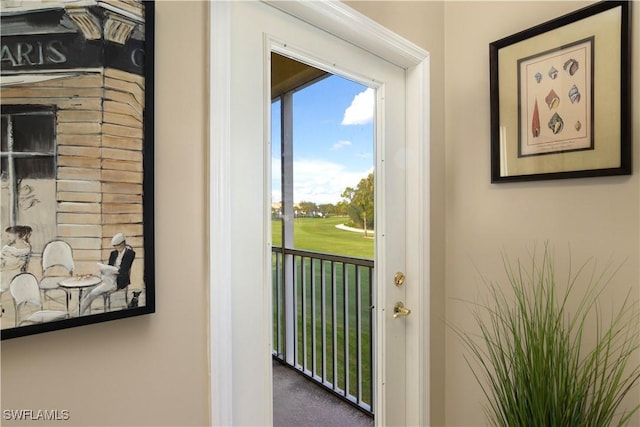 doorway to outside featuring carpet