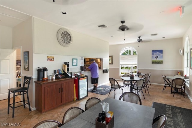 tiled dining area featuring ceiling fan