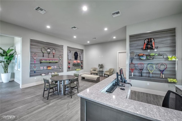 kitchen with light stone counters and hardwood / wood-style floors