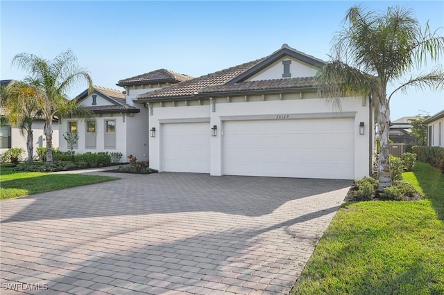 view of front facade with a garage and a front lawn