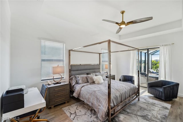 bedroom featuring ceiling fan, light hardwood / wood-style floors, and access to outside