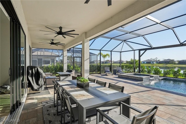 view of patio featuring a water view, ceiling fan, a swimming pool with hot tub, and glass enclosure