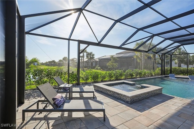 view of pool featuring an in ground hot tub, a lanai, and a patio