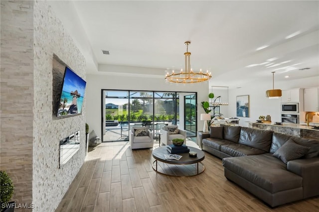 living room with hardwood / wood-style floors and a chandelier