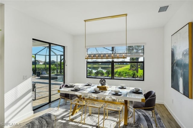 dining space with hardwood / wood-style flooring and plenty of natural light