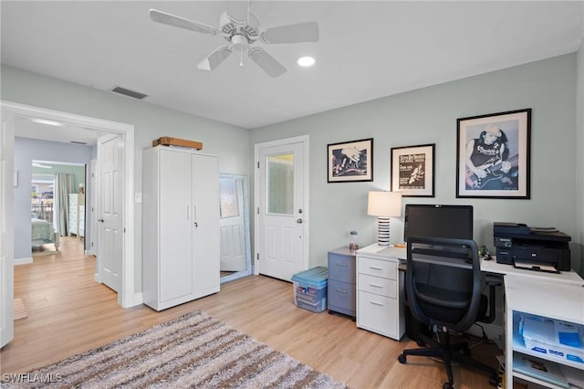 office with light hardwood / wood-style floors and ceiling fan