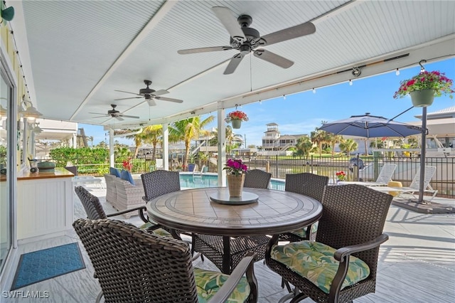 exterior space with a fenced in pool and ceiling fan