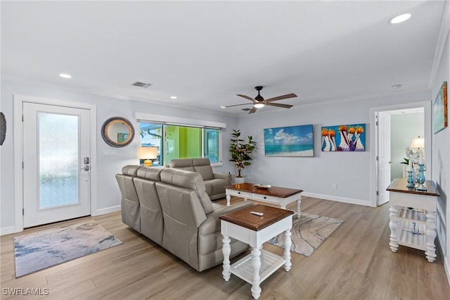 living room featuring crown molding and light wood-type flooring