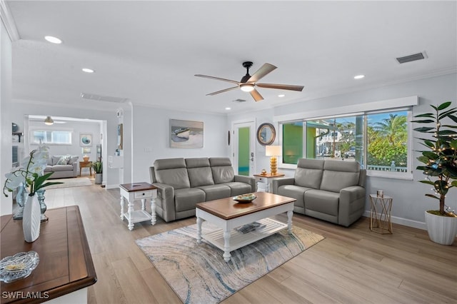 living room featuring crown molding, ceiling fan, and light hardwood / wood-style floors