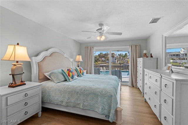 bedroom featuring ceiling fan, light hardwood / wood-style floors, multiple windows, and access to outside