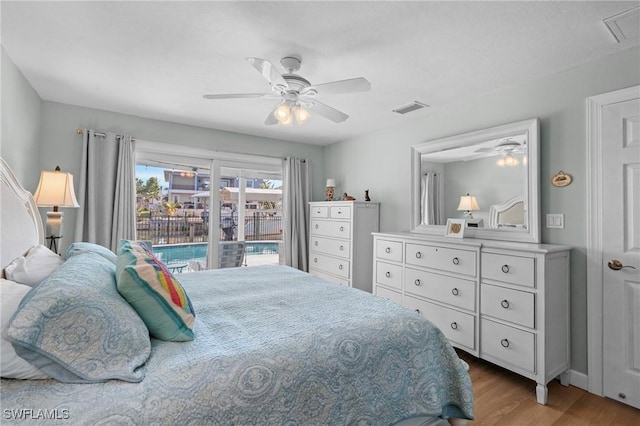 bedroom with access to exterior, light hardwood / wood-style floors, and ceiling fan