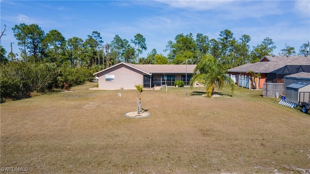 view of front of property featuring a front lawn and a sunroom