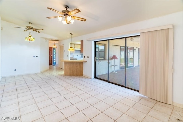 tiled empty room with ceiling fan