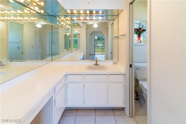 bathroom featuring ceiling fan, tile patterned floors, toilet, and vanity