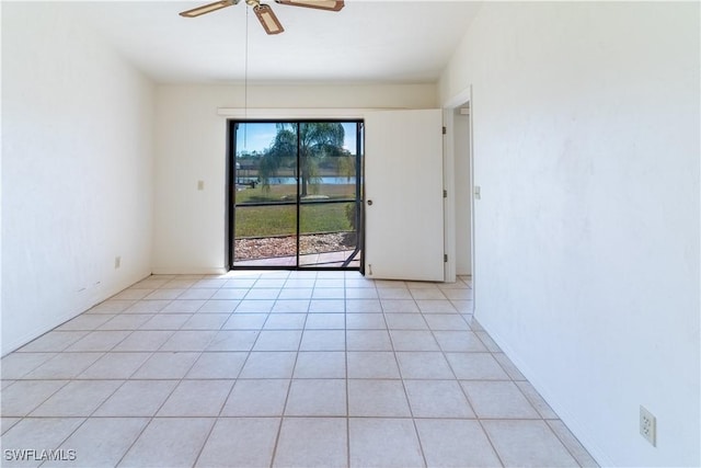 empty room with ceiling fan and light tile patterned floors