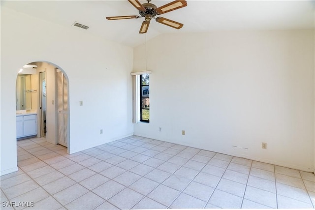 unfurnished room featuring light tile patterned flooring, lofted ceiling, and ceiling fan