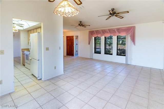 empty room featuring light tile patterned floors and ceiling fan