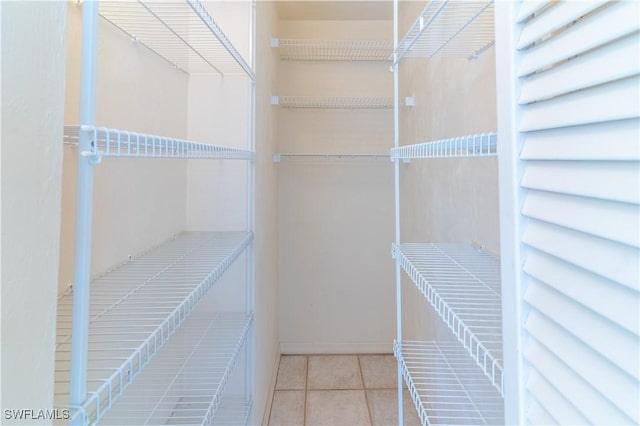 spacious closet featuring light tile patterned flooring