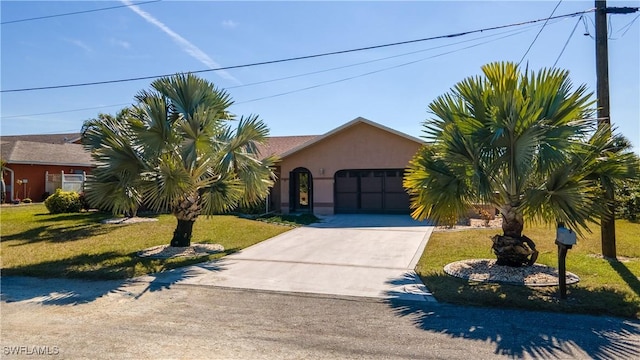 view of front of house with a garage and a front yard