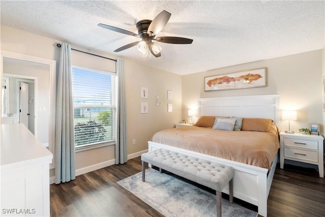 bedroom with a ceiling fan, baseboards, a textured ceiling, and dark wood-style flooring