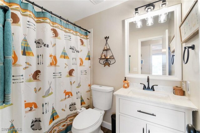 bathroom with vanity, toilet, and a shower with shower curtain