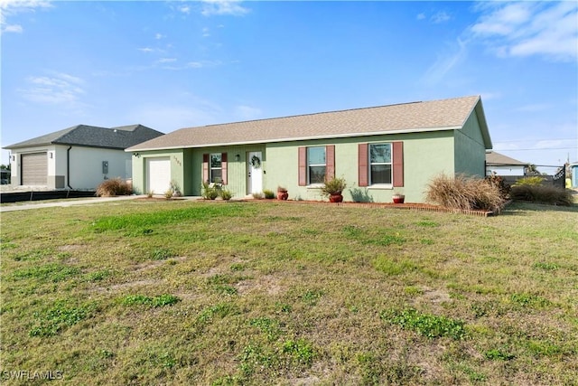 ranch-style house featuring a garage and a front lawn