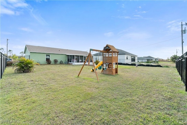 exterior space with a lawn and fence