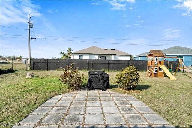 view of patio / terrace featuring a playground and fence