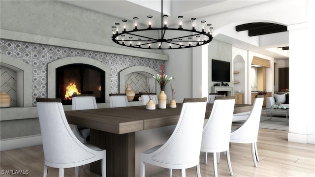 dining space featuring a notable chandelier and light wood-type flooring