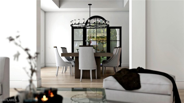 dining room with a notable chandelier and hardwood / wood-style flooring